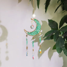 Load image into Gallery viewer, Decorative hanging moon and star ornament with green gemstones and colorful beads against a light background.