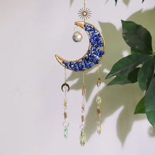 Load image into Gallery viewer, Decorative hanging ornament with blue stones and gold accents against a light background.
